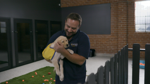 Pet Express team member holding a cute puppy